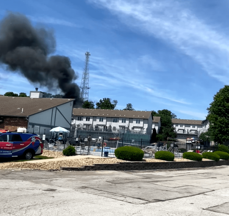 Flames pop through roof during condo fire in St. Charles