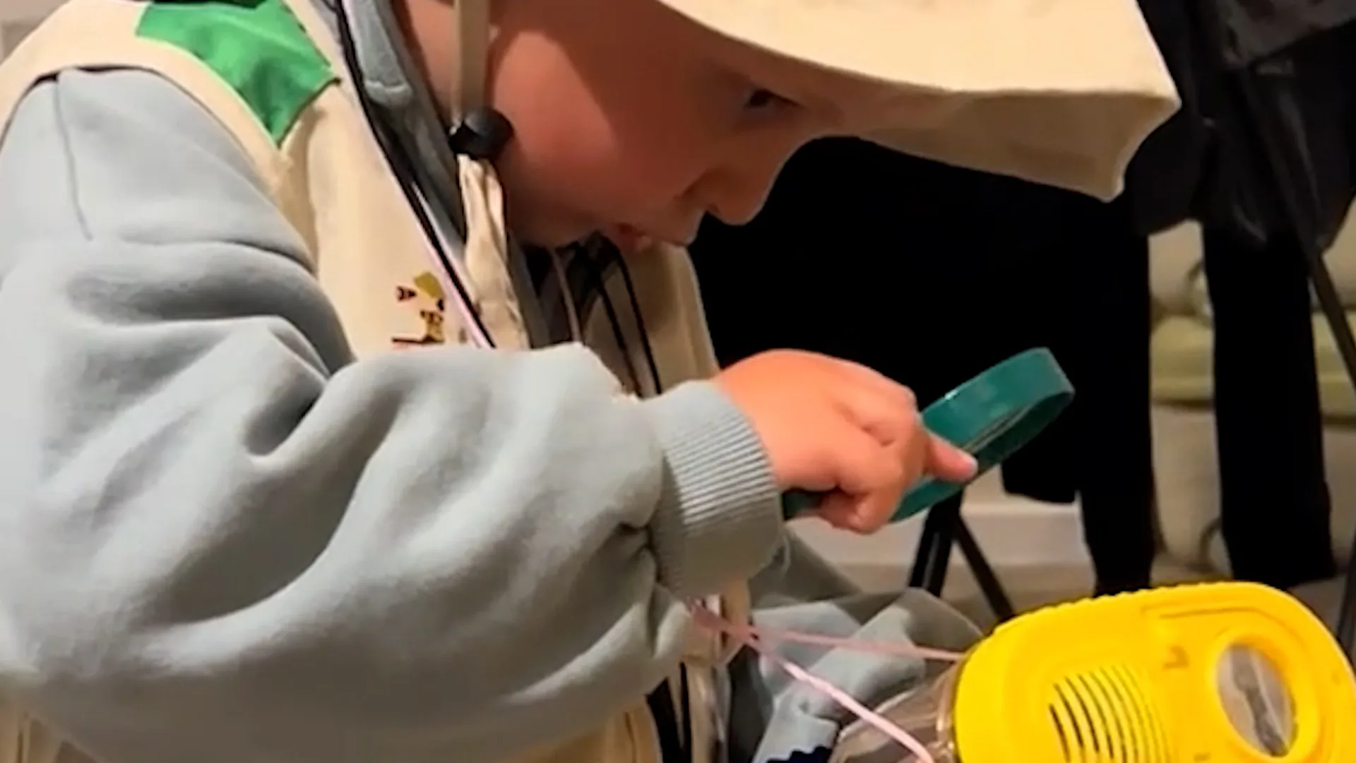Tiny wildlife enthusiast in full kit shows off catch after backyard ...