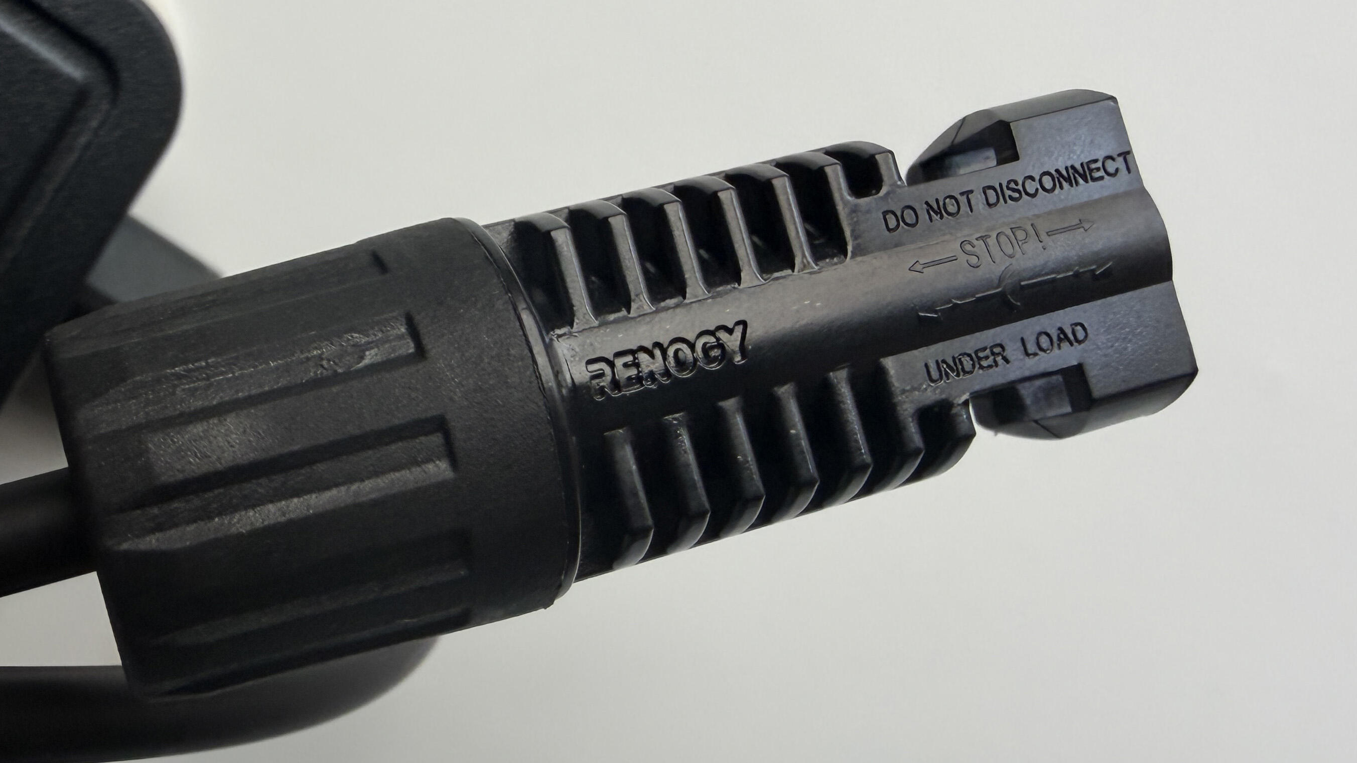 An MC4 connector - Note the tiny "Do not disconnect under load"