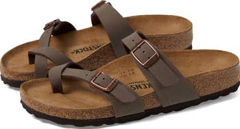 Two brown Birkenstock sandals with cork soles and adjustable straps