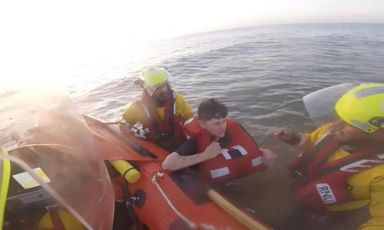 Moment beachgoer is saved from drowning after getting trapped in ...