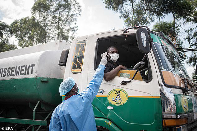 A health worker in a protective gown and mask checks locals' temperature as a preventive measure against Ebola in Kanyaruchinya, near Goma, North Kivu, Democratic Republic of Congo, 27 May 2026