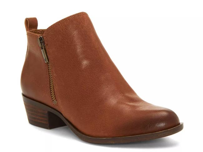 Brown ankle boot with a low chunky heel and side zipper, suitable for casual or formal wear