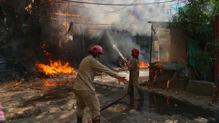 Firefighters tackle a blaze in New Delhi, India (Manish Swarup/AP)