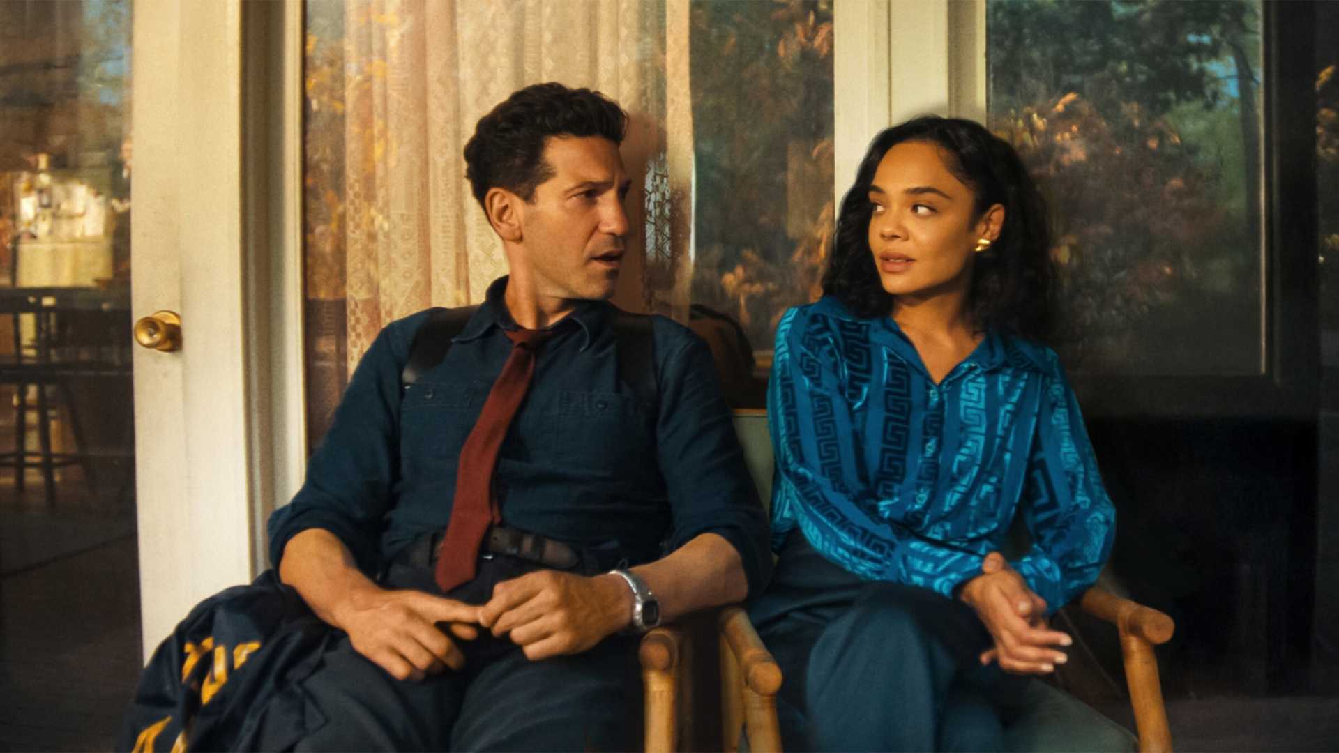 Jon Bernthal and Tessa Thomson sitting next to each other, eyeing each other up in His & Hers