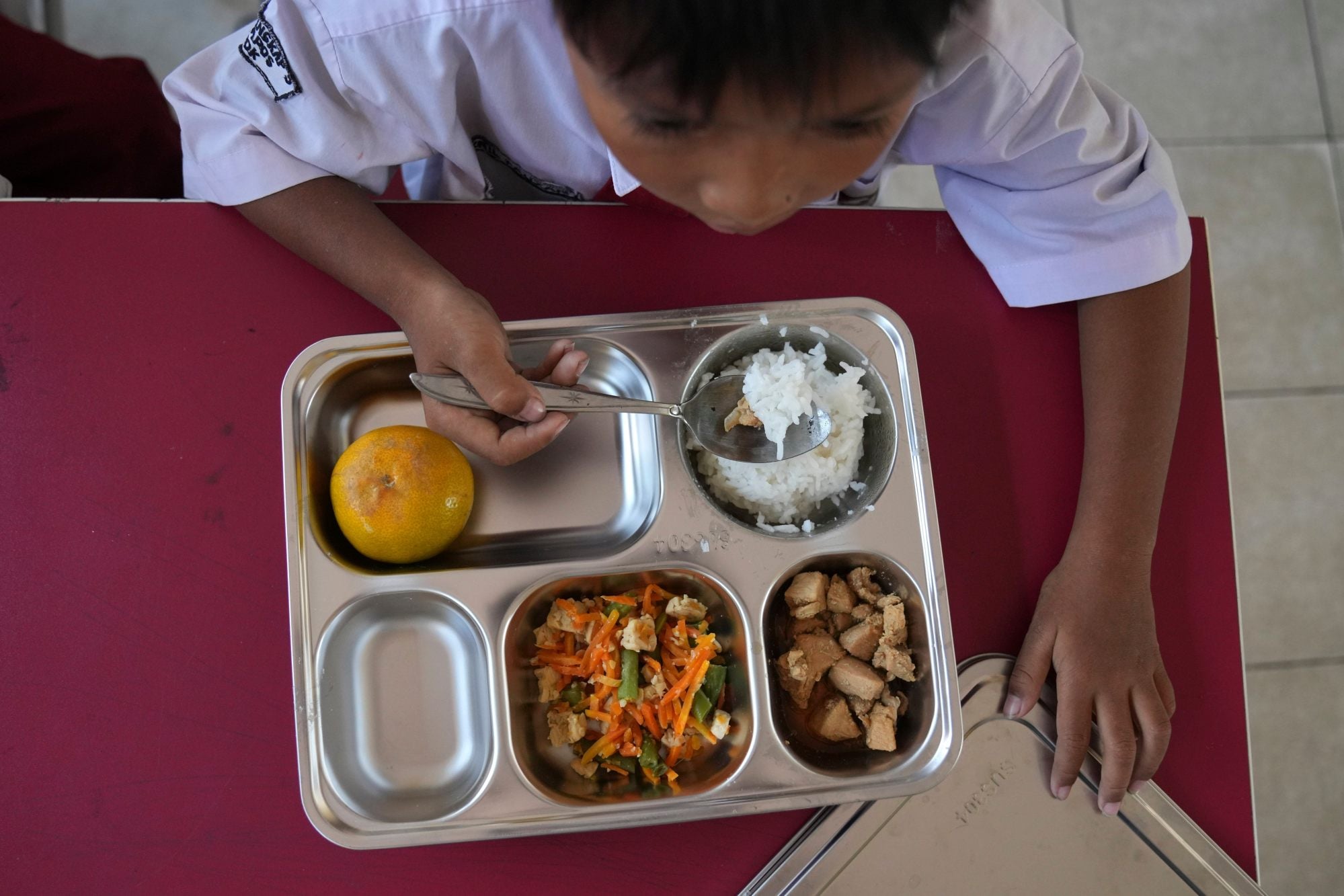 A student has his meal as President Prabowo Subianto's ambitious free meal programme begins, in January 2025. Photo: AP