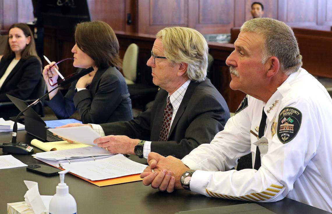 Franklin County Sheriff Jim Raymond sits with his attornery's as Walla Walla Superior Court Judge Brandon Johnson sets a deadline for turning over a fingerprint machine during Wednesday's court hearing at the Franklin County Courthouse in Pasco. Megan Clark, the attorney representing Franlin County, is seated at far left. Attorneys Rebecca Boatright and Randall Gaylord are in the middle. Bob Brawdy/bbrawdy@tricityherald.com