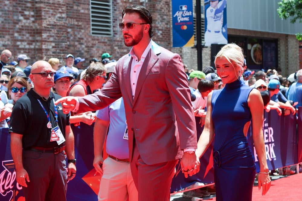 Jul 15, 2025; Atlanta, GA, USA; National League pitcher Paul Skenes (30) of the Pittsburgh Pirates and social media influencer Livvy Dunne walk on the red carpet before the 2025 MLB All Star Game at Truist Park. Mandatory Credit: Brett Davis-Imagn Images