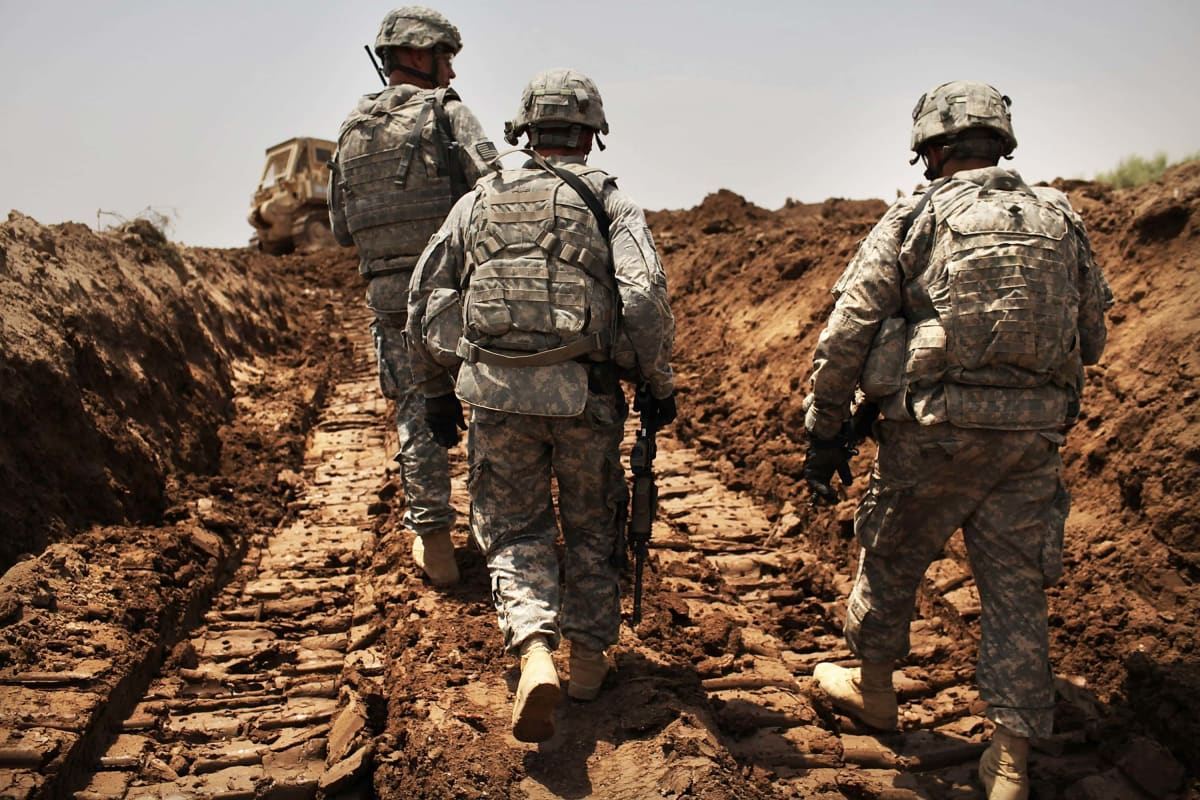 ISKANDARIYA, IRAQ - JULY 19: U.S. soldiers with the 3rd Armored Cavalry Regiment patrol a new ditch