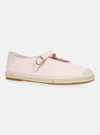 Mary Jane espadrille with a buckle strap and textured detail on the toe, set against a simple background