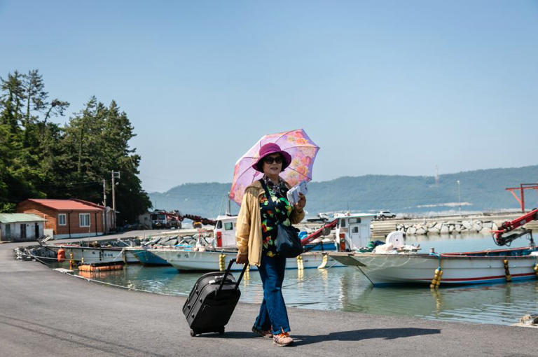 Son's photobook honors mother's 43-year island mail delivery career