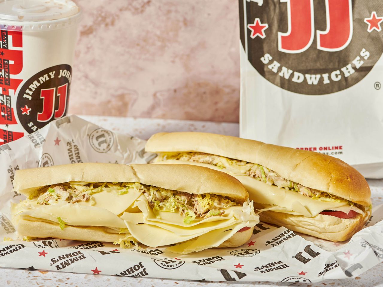 Jimmy John's tuna sandwiches with shredded lettuce and branded packaging.