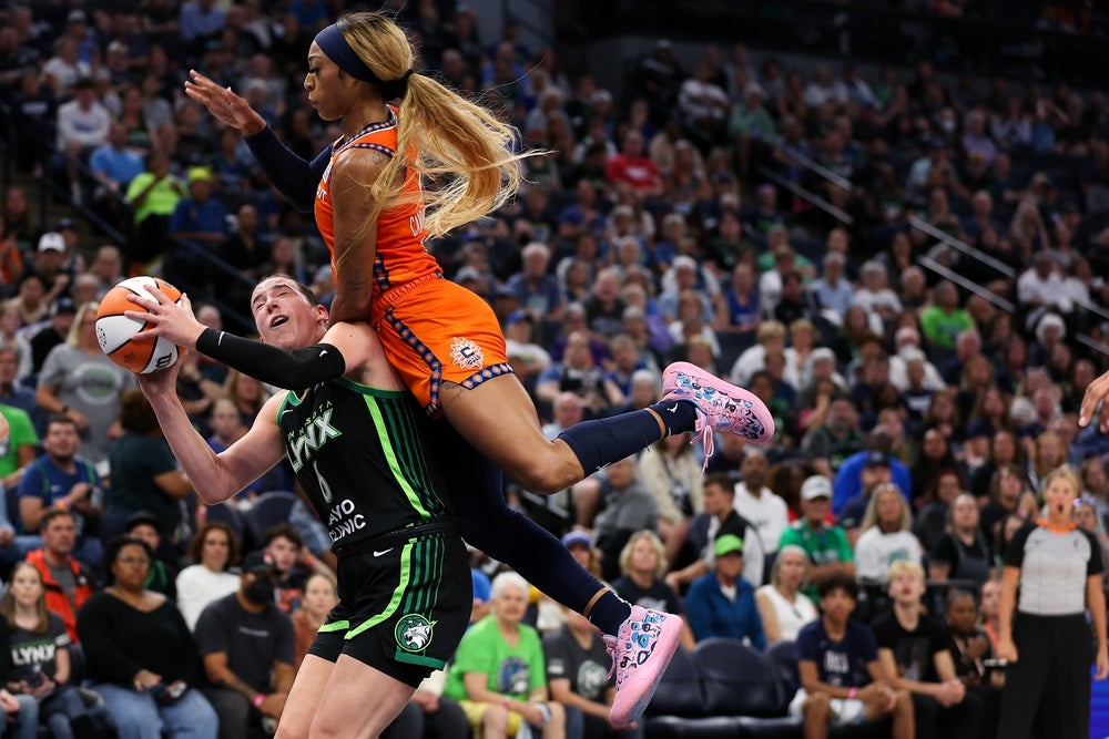 Sep 29, 2024; Minneapolis, Minnesota, USA; Connecticut Sun guard DiJonai Carrington (21) fouls Minnesota Lynx forward Bridget Carleton (6) during the second half of game one of the 2024 WNBA Semi-finals at Target Center. Mandatory Credit: Matt Krohn-Imagn Images