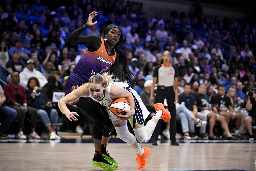 Sep 11, 2025; Arlington, Texas, USA; Dallas Wings guard Paige Bueckers (5) is fouled by Phoenix Mercury guard Kahleah Copper (2) during the first half at College Park Center. Mandatory Credit: Jerome Miron-Imagn Images