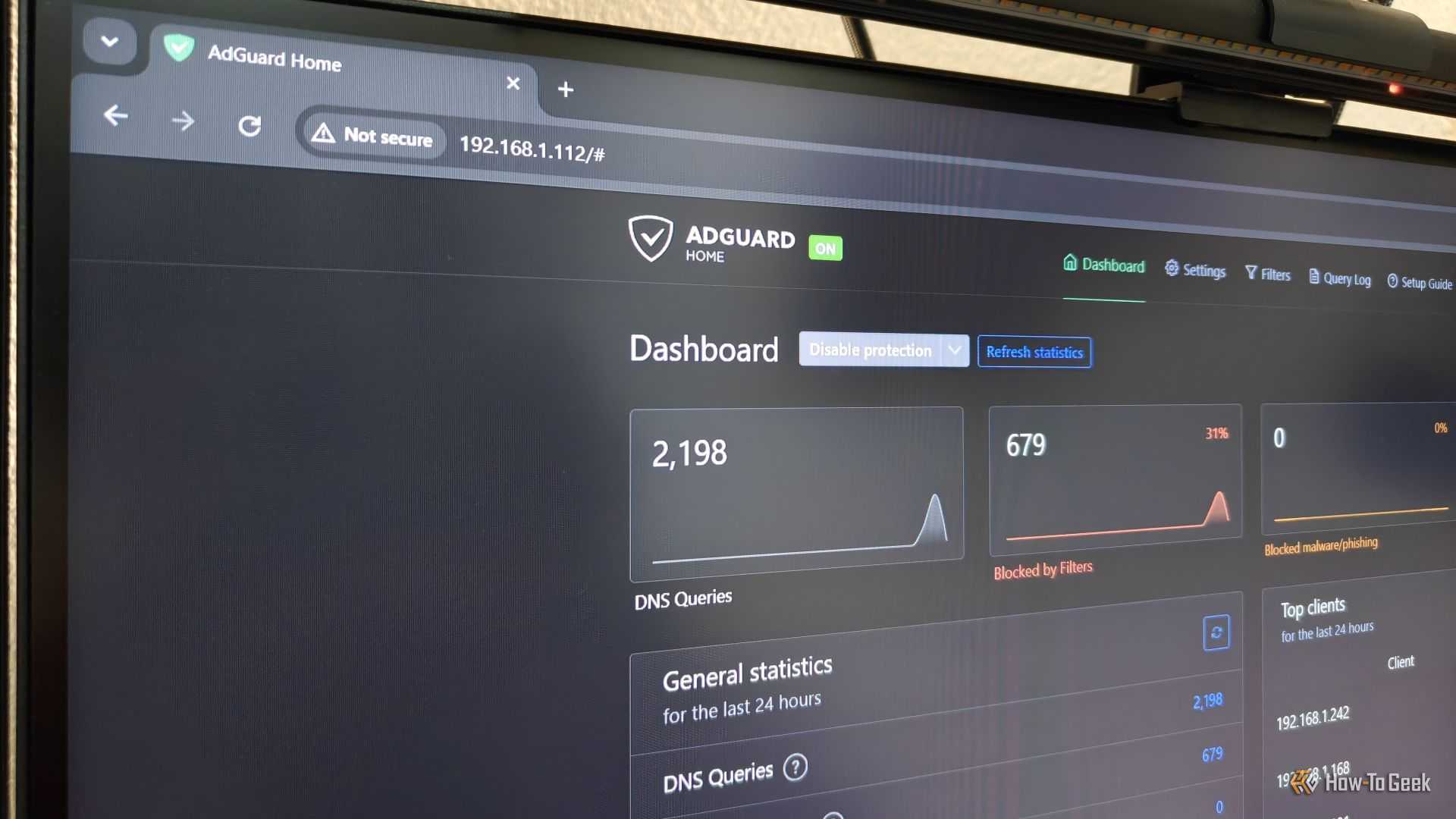 AdGuard Home dashboard being displayed on a computer monitor.