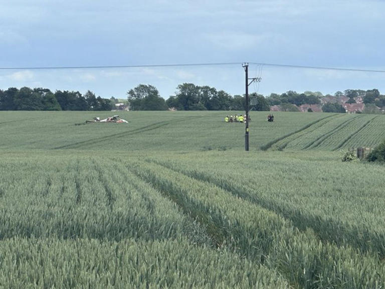Two people rushed to hospital after aircraft crashes into field near ...