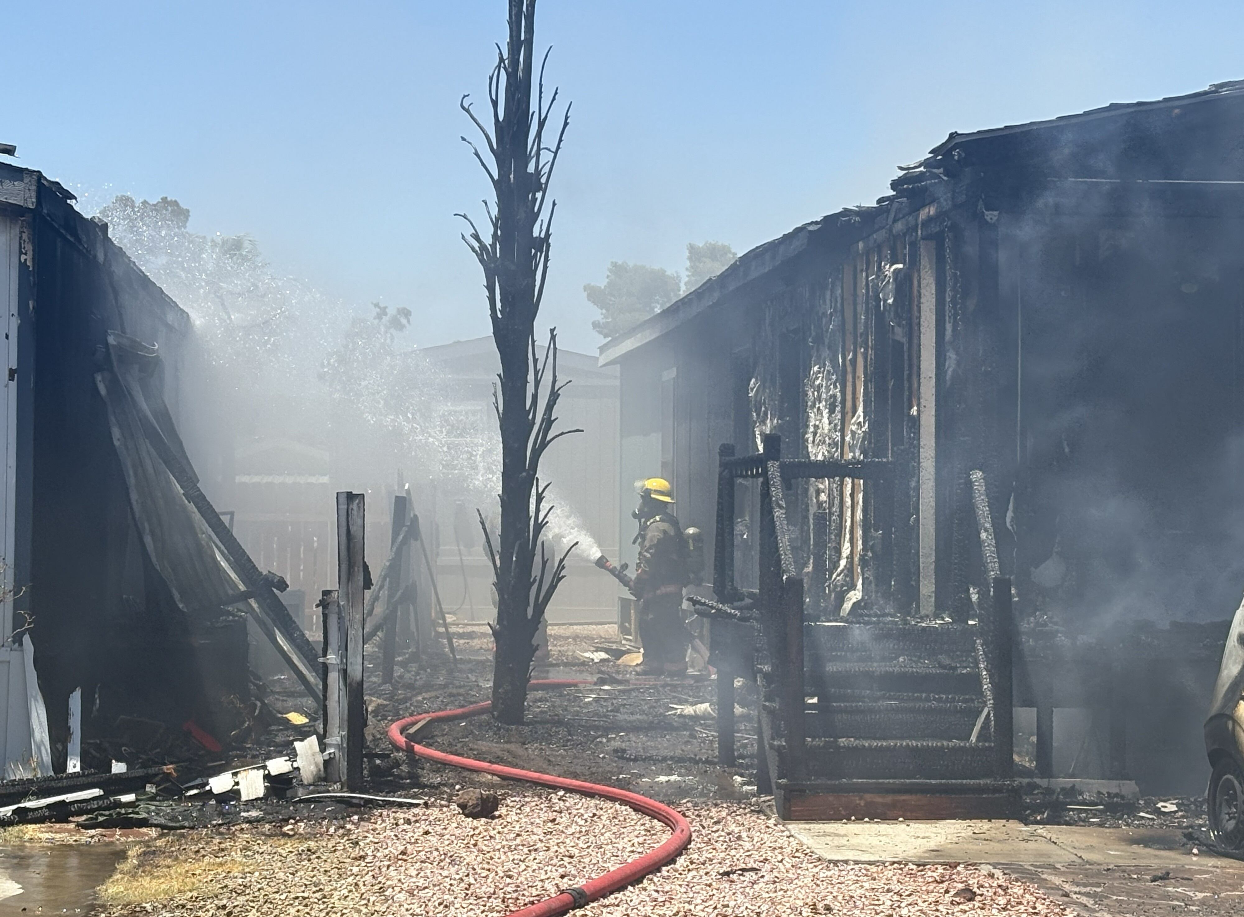 Fire crews knock down mobile home blaze near Tropicana, Jones