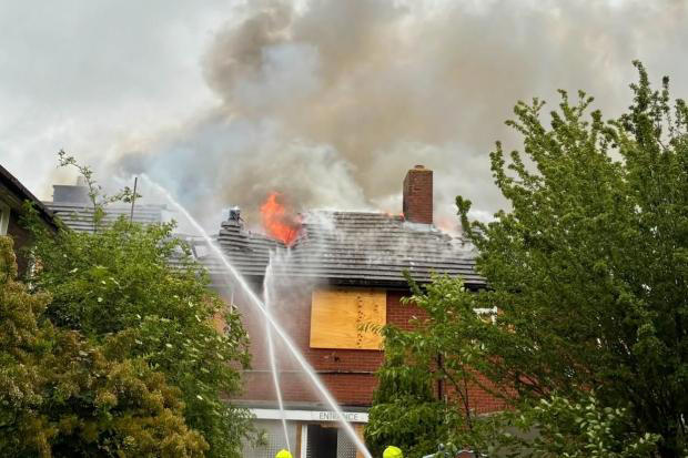 Huge fire rips through roof of building
