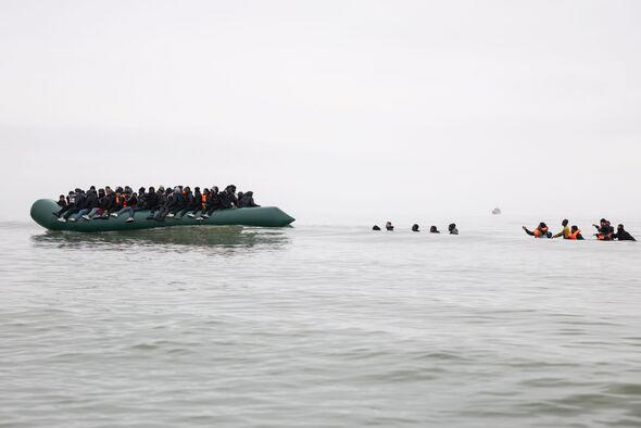 Migrants in small boat photographed from distance