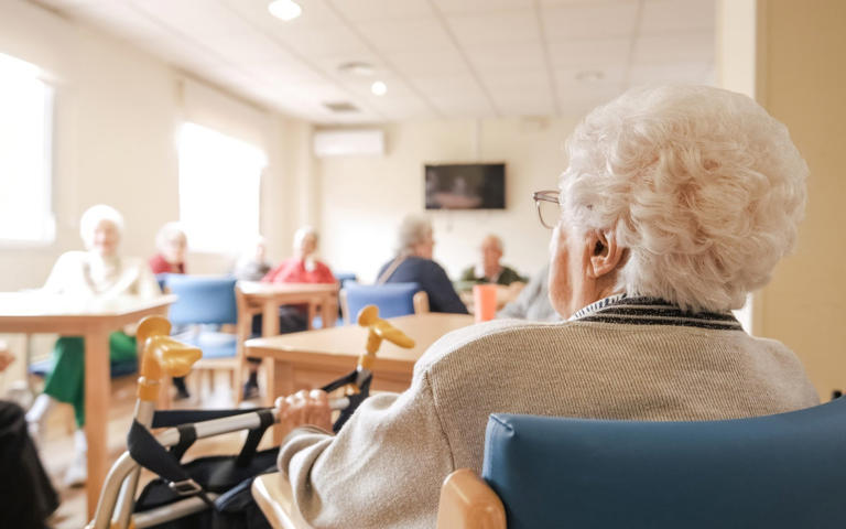 Woman sitting down in a care home