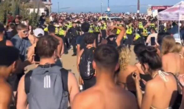 Crowd and police on Bournemouth Beach