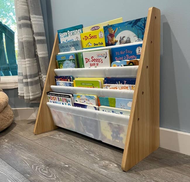 a reviewer photo of the book rack loaded with children's books in white