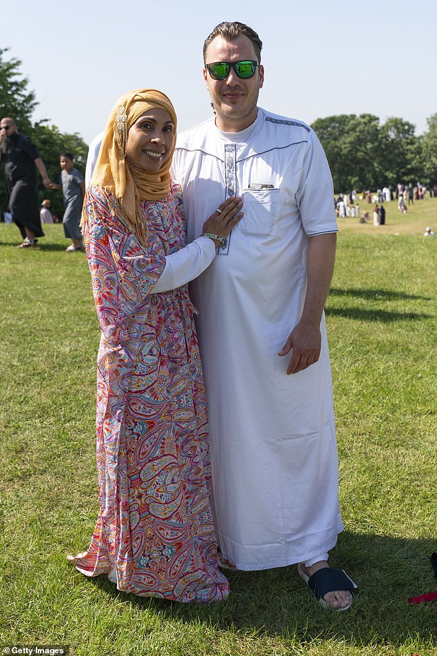 A couple posed in their finery in London on the second day of the celebrations