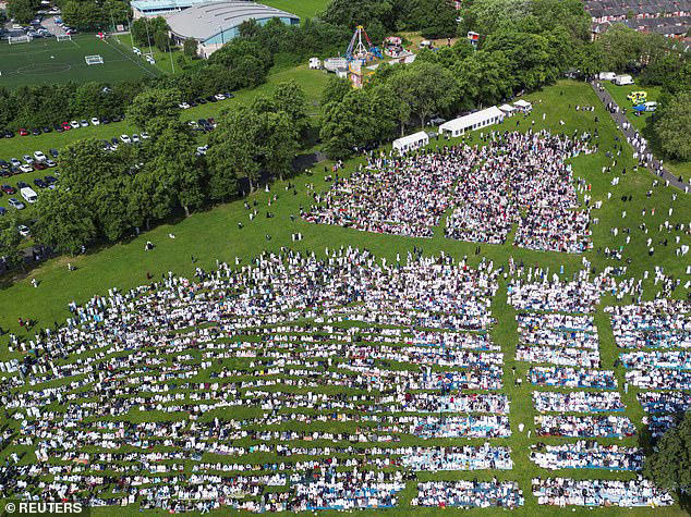 Hundreds of Muslim faithful attended Eid al-Adha prayers in Manchester today. Pictured: A drone view of Platt Fields Park 