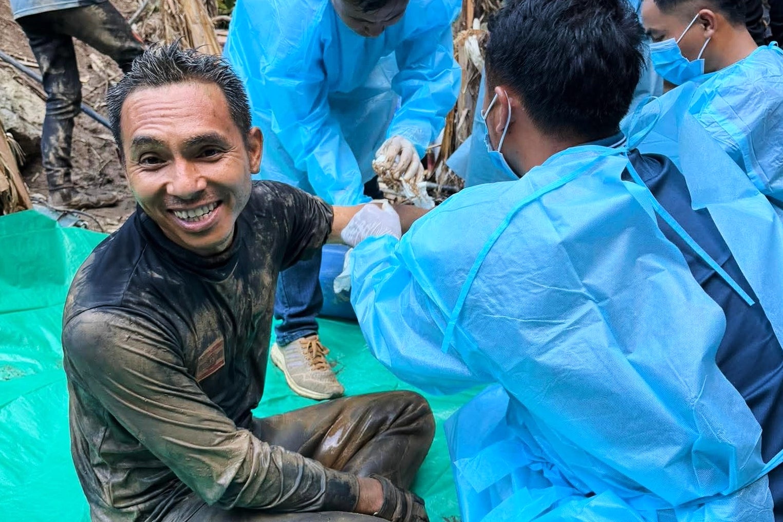 Metta Tham Rescue Kalasin, rescuers, left, sit after rescuing people who have been trapped in a cave in Xaisomboun province, Laos. Wednesday (AP)