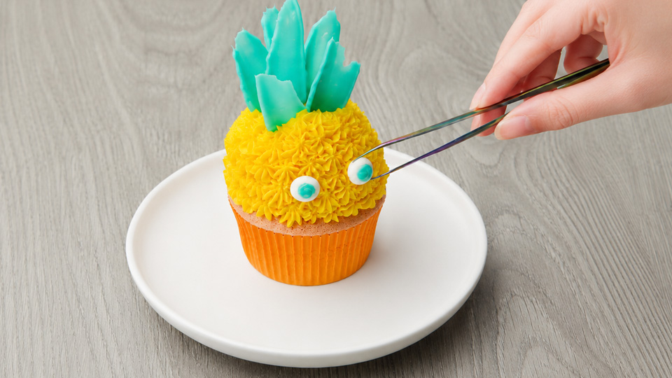 Yellow frosting creates a fun pineapple cupcake