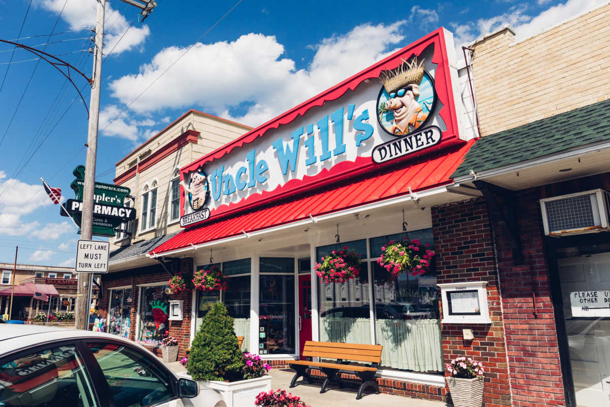 Uncle Will's exterior with brick walls and a bench out front