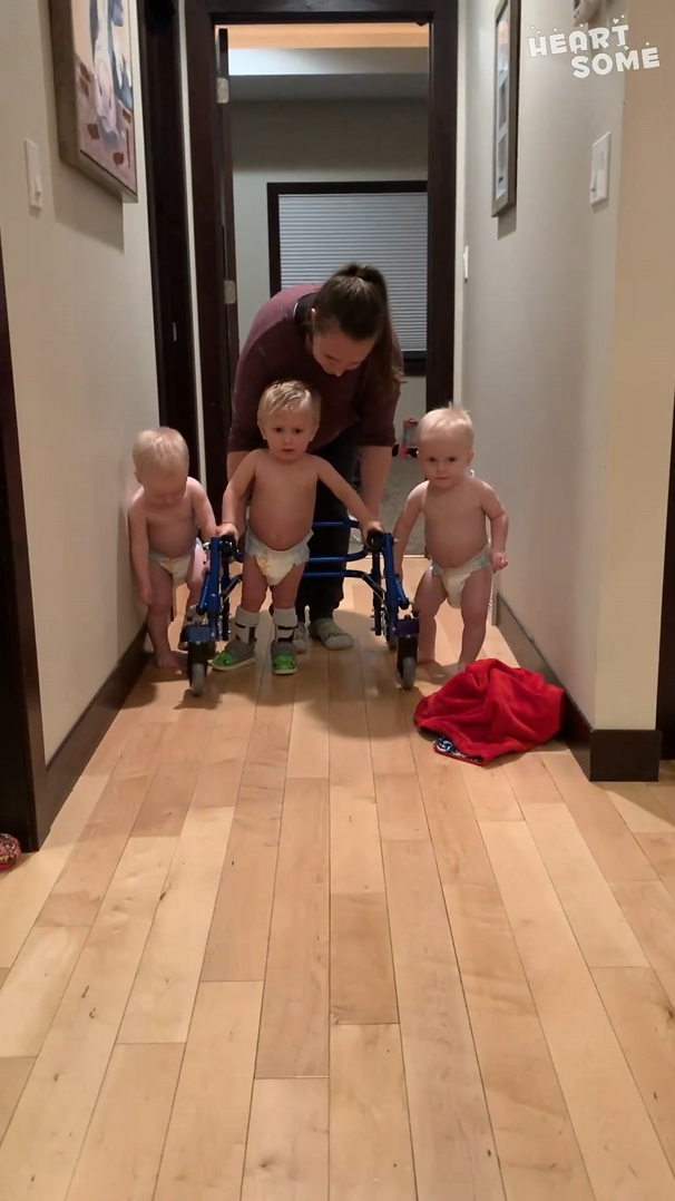 Brothers stay by triplet’s side as he learns to walk