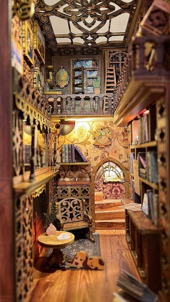 Intricately detailed miniature library room with books, ornate decor, and a cozy chair, creating a warm and inviting atmosphere for browsing