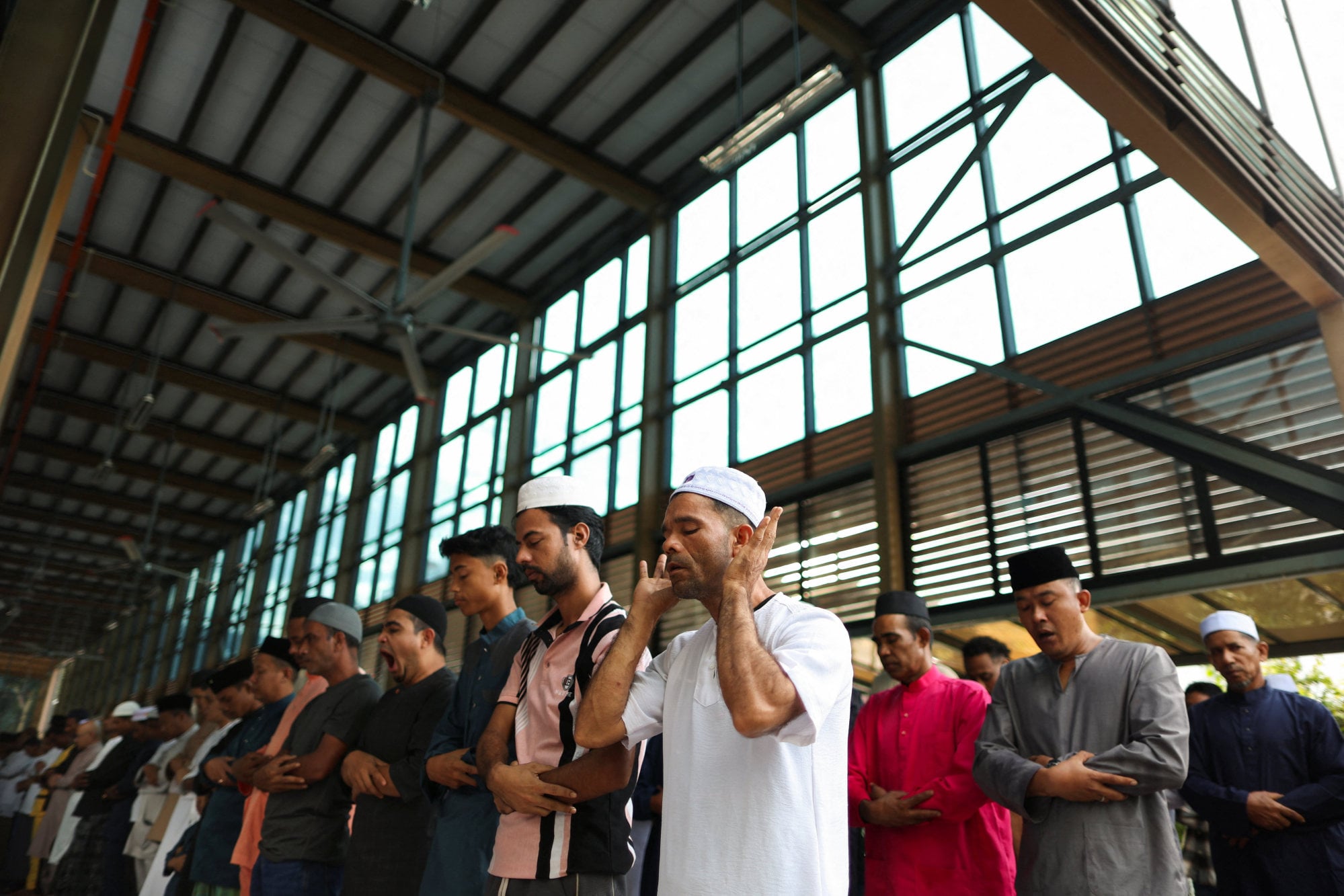 Muslims perform Eid ul-Adha mass prayers at a mosque in Ampang, Malaysia, on Wednesday. Islam is the religion of the Malaysian federation and Muslims make up 20.6 million people. Photo: Reuters