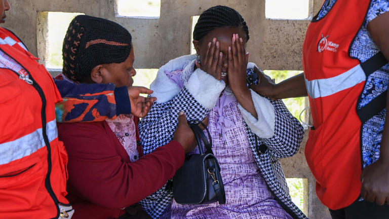 A parent mourns after the fire killed 16 students. Pic: AP