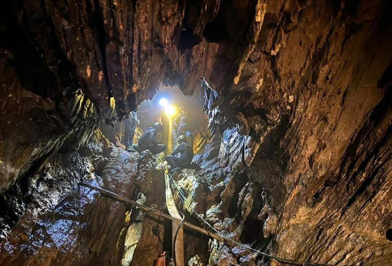 First of five men found alive in flooded Laos cave rescued