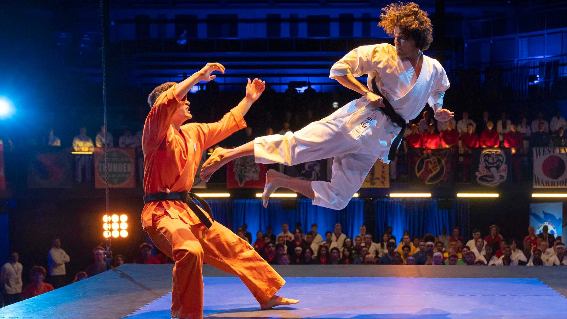 Miguel performs a flying kick in Cobra Kai.
