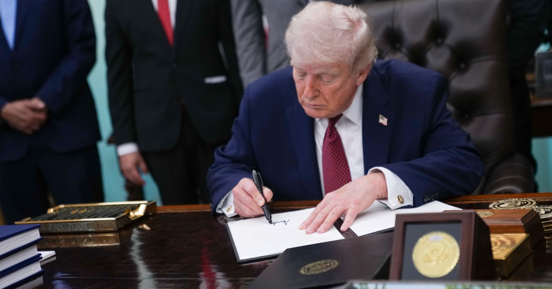 U.S. President Donald Trump signs an executive order on researching the effects of psychedelic drugs in medical treatment for veterans, on Saturday, April 18, 2026 in the Oval Office at the White House in Washington, D.C.