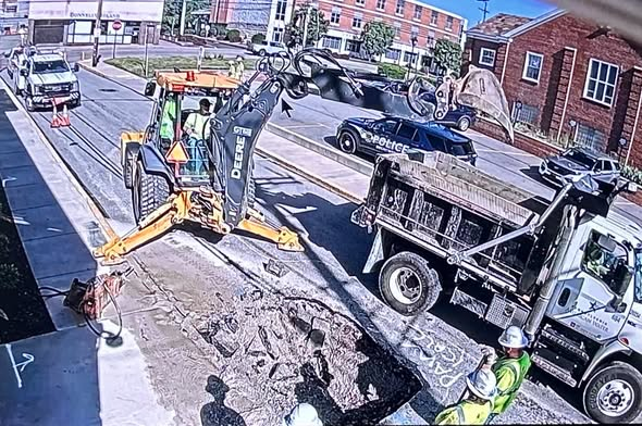 Repairs underway outside local police station following water main break