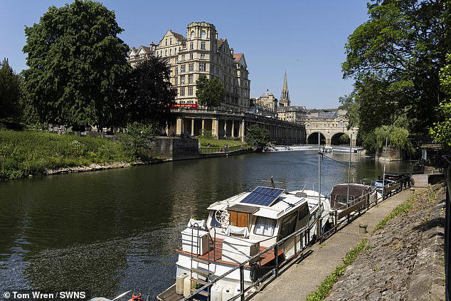 Houseboats moored along the River Avon enjoy a picturesque view of Bath's famous Pulteney Bridge