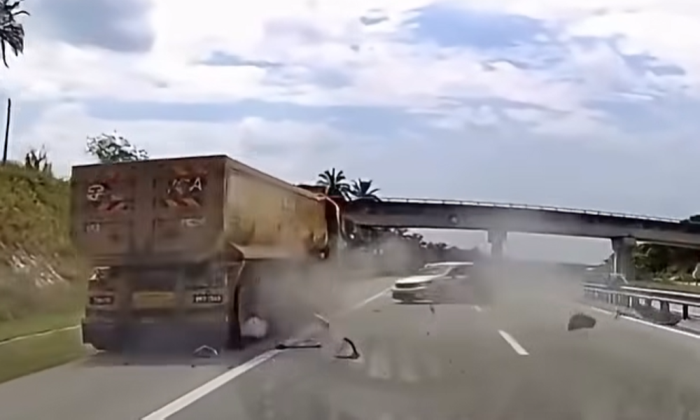 Driver escapes unhurt as car smashes into lorry after striking shaft on ...