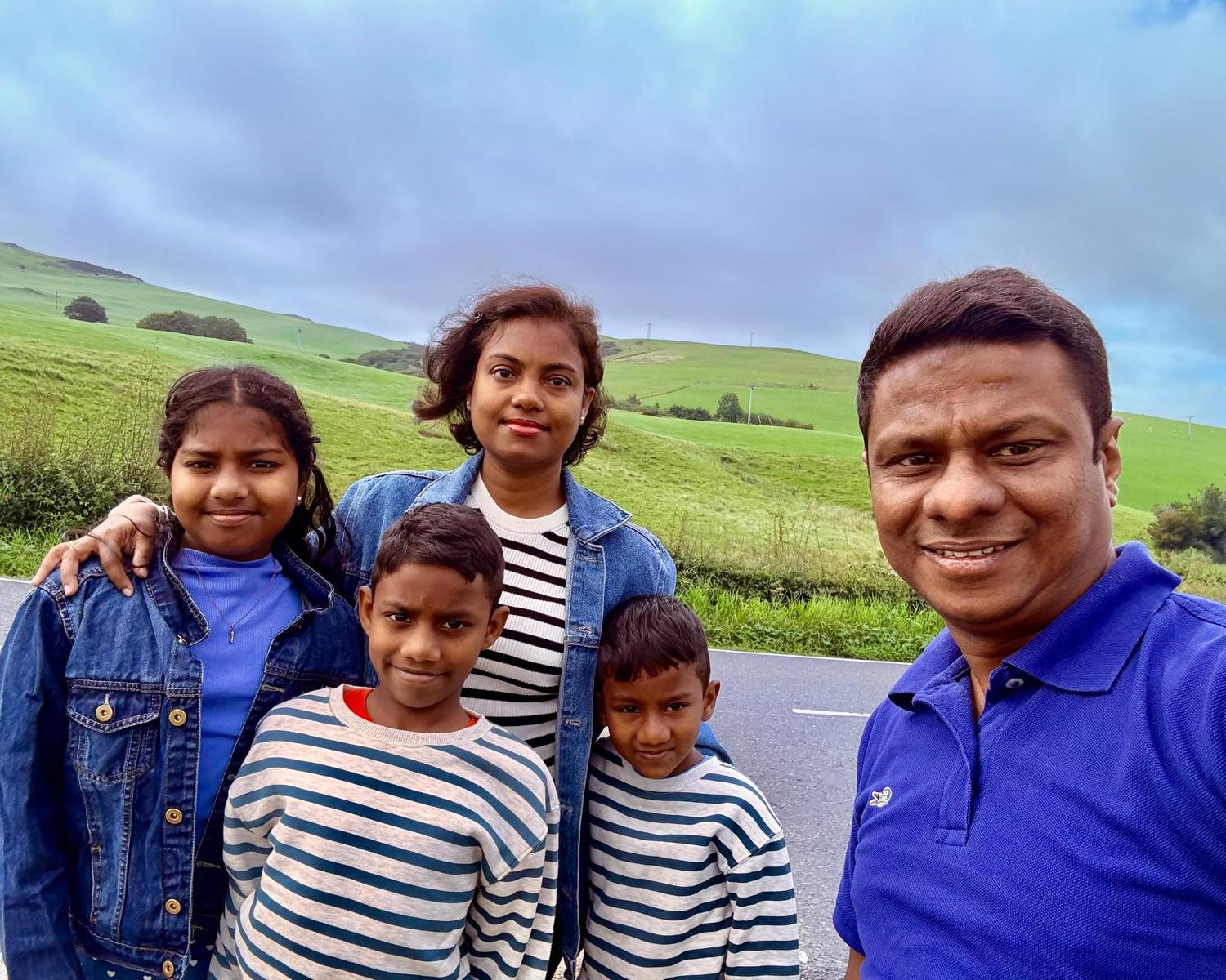 Rasika Samarasinghe, a care worker who arrived in 2022, with his wife and children – who have now been told they must leave. Photograph: Courtesy of Samarasinghe family
