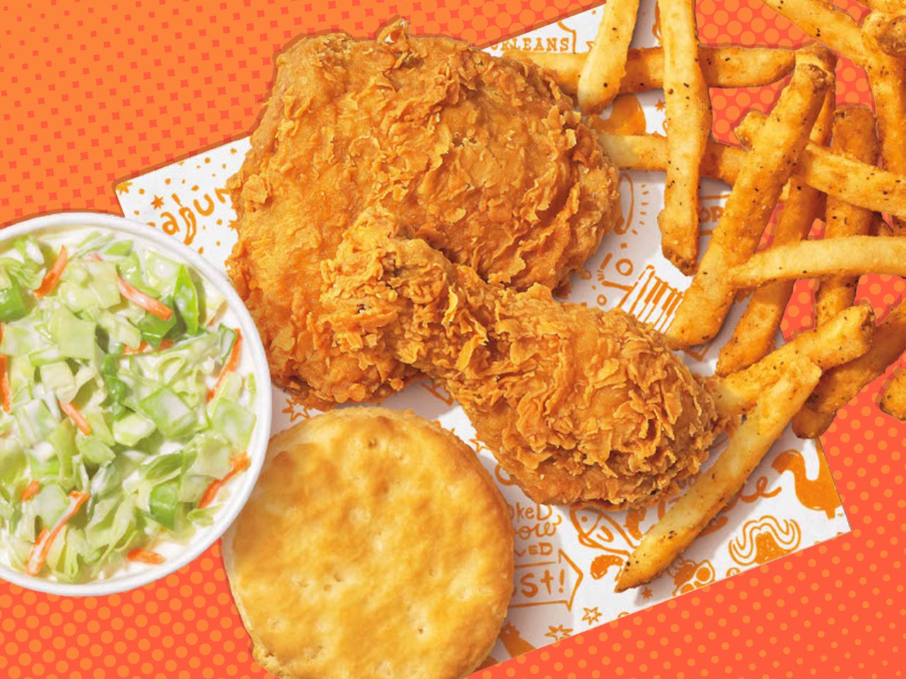 Popeyes Big Box including two chicken tenders, a buttermilk biscuit, fries, and coleslaw on an orange halftone background