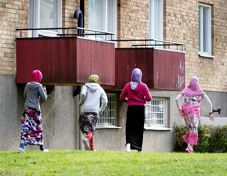Migrant girls from Africa run beside their apartment house in Flen, 30 August, 2018 AP Photo