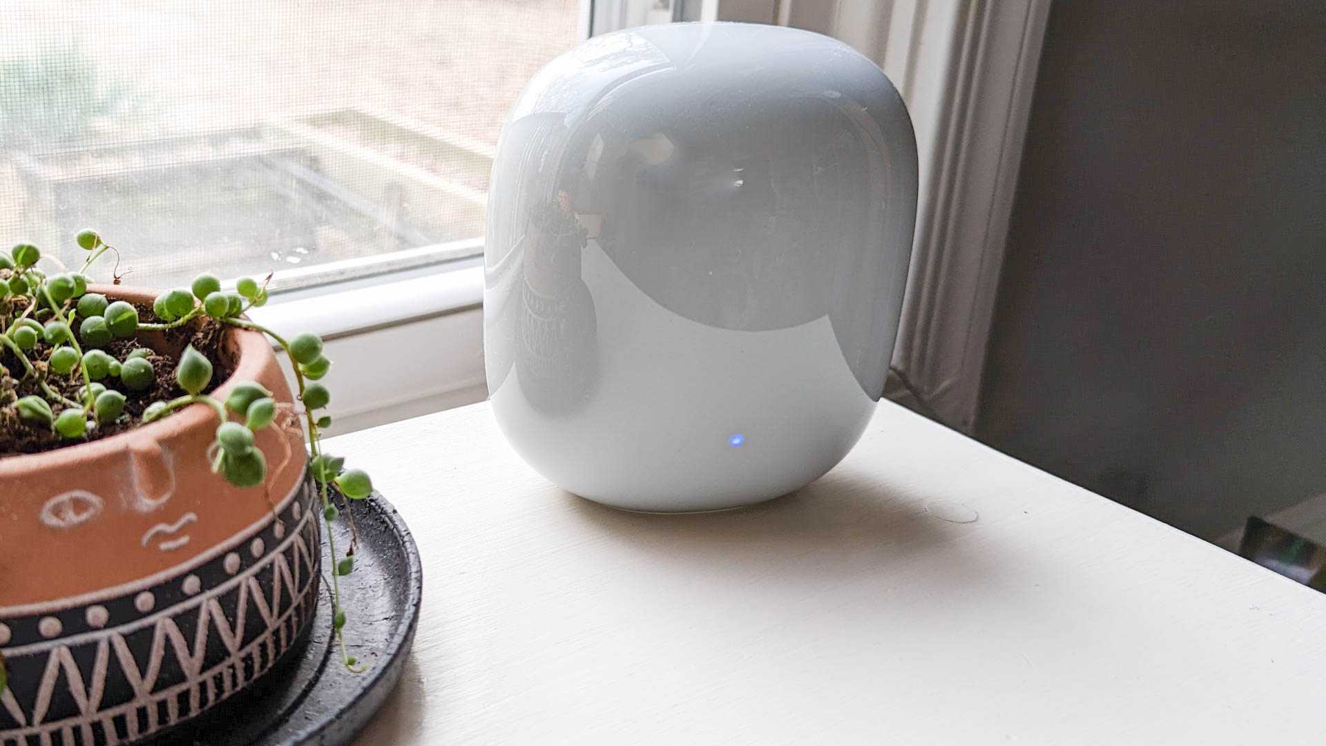 Nest Wifi Pro mesh router with the blue system update indicator light.