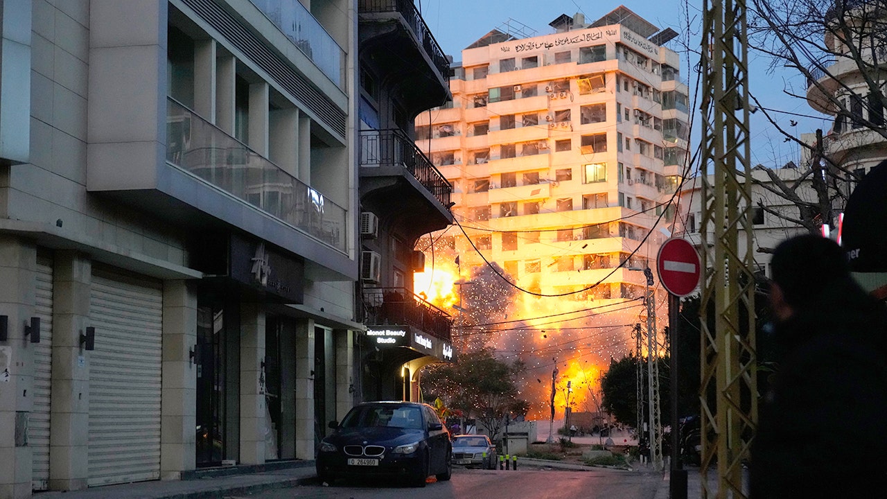 An explosion erupts from a building following an Israeli strike in central Beirut, Lebanon, on March 18, 2026.