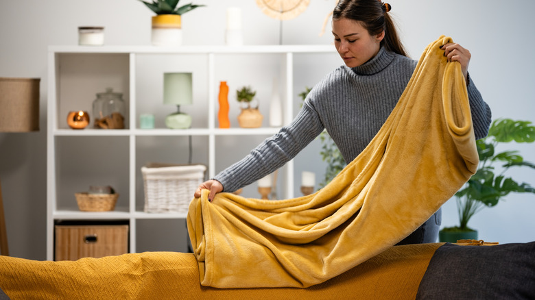 Upcycle an old wine rack to create blanket storage with a clever DIY