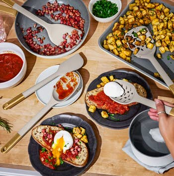 Cookware set displayed with a preparation of toast topped with sauce, poached egg, and diced potatoes, highlighting cooking tools and food presentation
