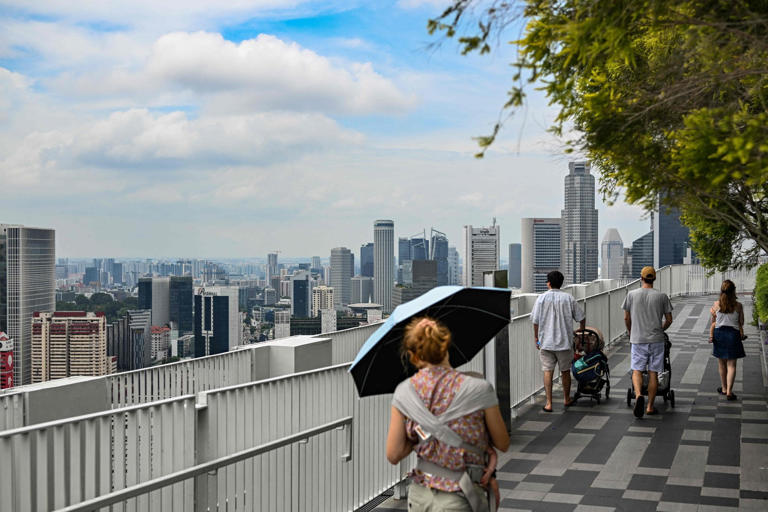 People look out from a vantage point in Singapore. Temperatures in the city state are rising twice as fast as the global average. Photo: AFP