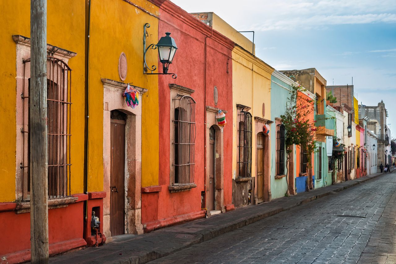 A street with colorful colonialstyle houses in Quertaro Mexico